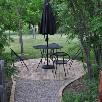 1702 Brick Lined Gravel Path to Circular Brick Patio